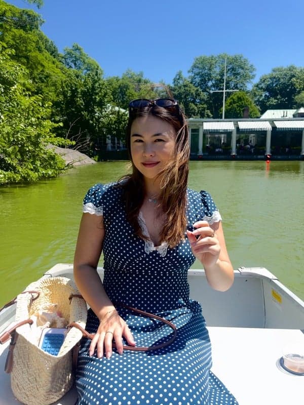 McKenna Velasco seated on a boat in a park lake.